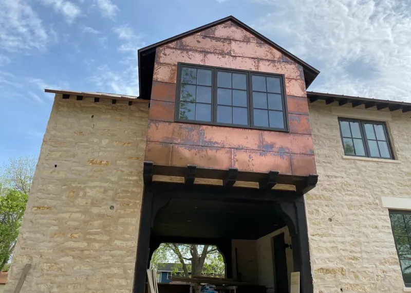 Copper metal panel facade on a stone building for Metal Roof Coating in Jackson